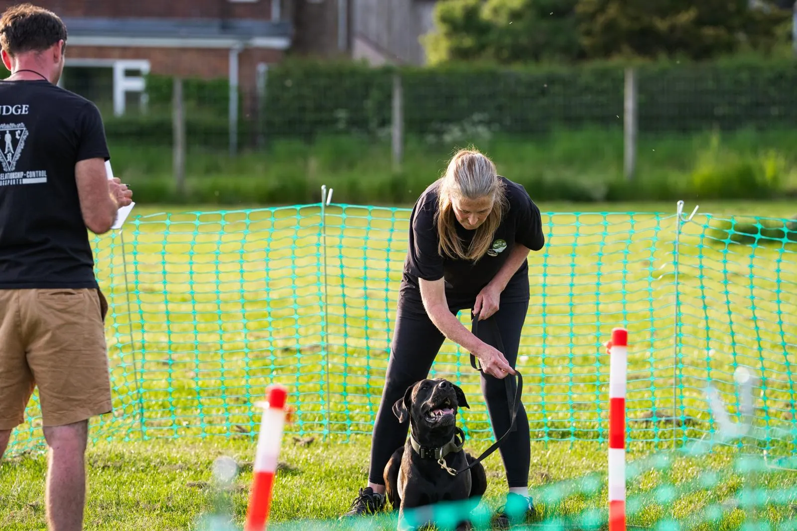 Caroline and her dog at a Unity 32 trial, with the judge watching